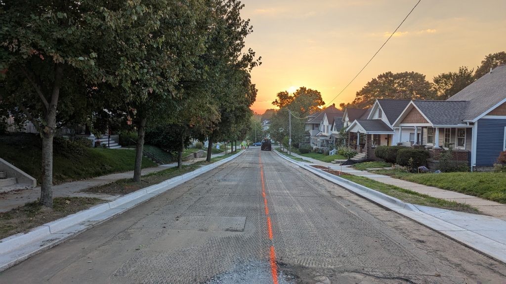 A road crew preparing a street for a new layer of asphalt.